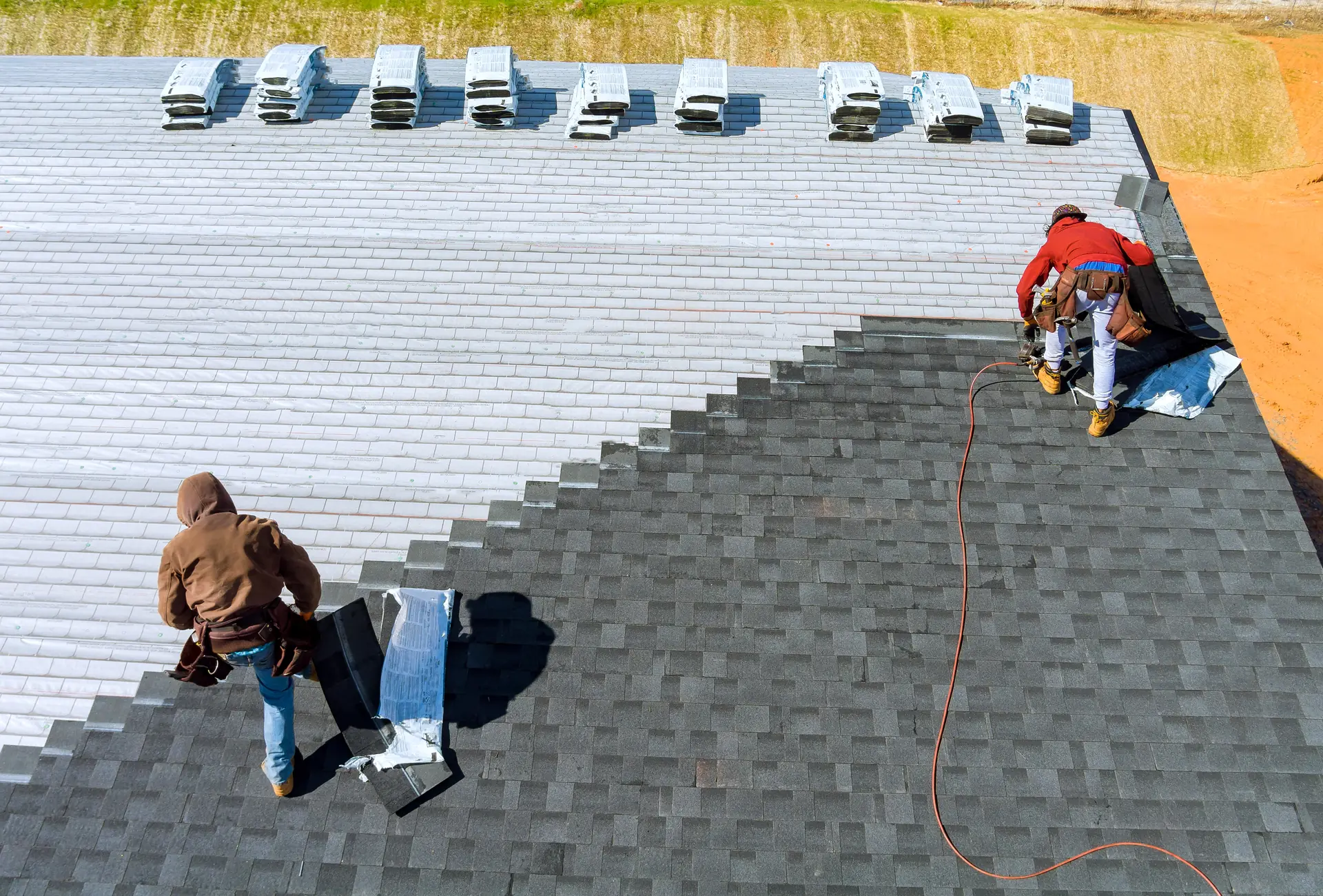 Roofer installing asphalt shingles on a Lone Tree, CO home